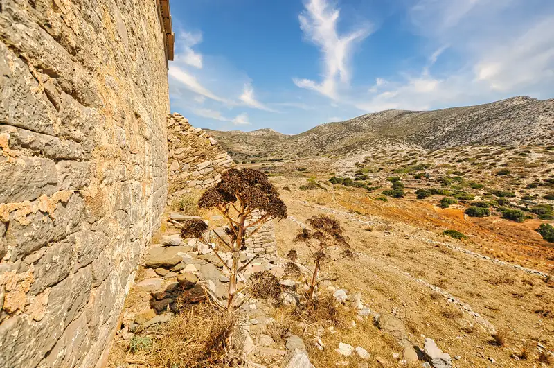 The old exterior wall of Episkopi looking over the dry slopes of Sikinos