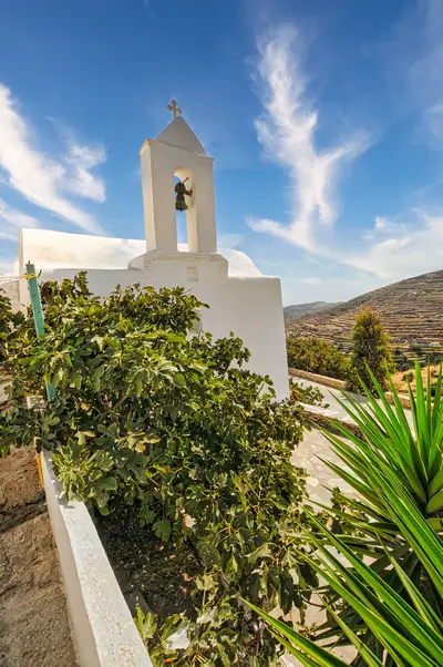 Small Cycladic church framed by figs and aloe in Kastro on Sikinos island