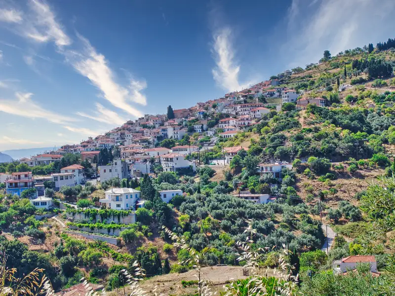 Glossa village climbing the green slope above the sea on Skopelos island