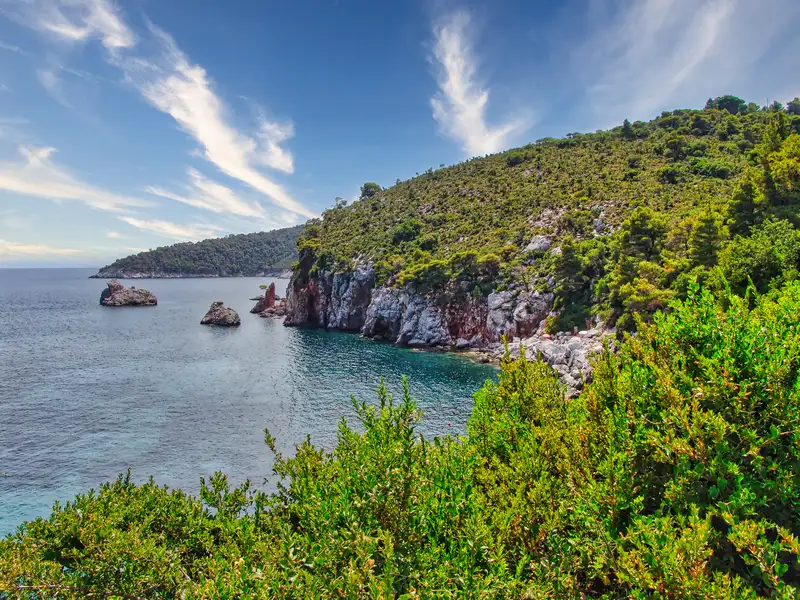 Rocky headlands and pine-covered cliffs along the coast of Skopelos island
