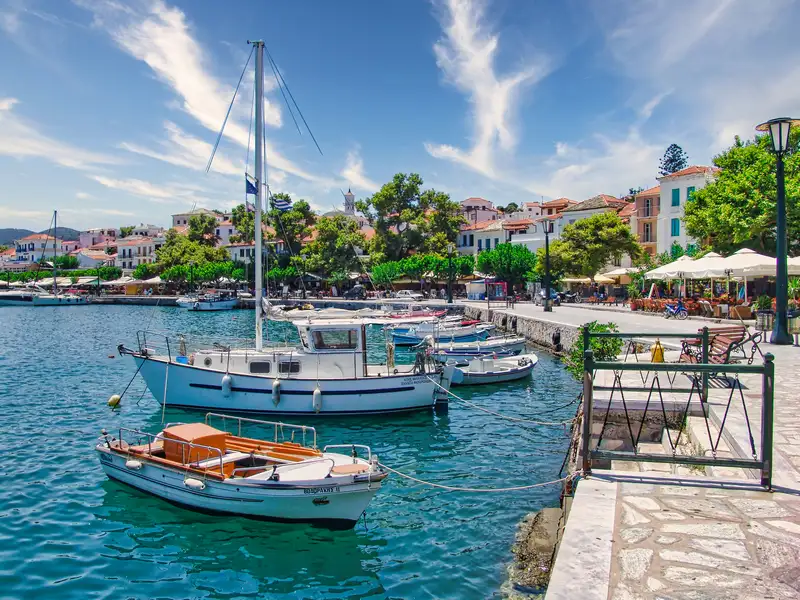 The quay and old town of Skopelos seen across the calm harbour water