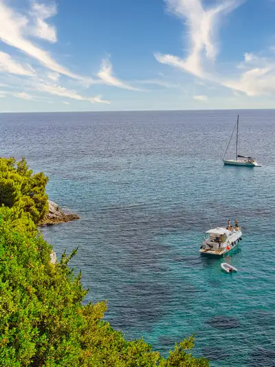 Sailing boats anchored in the deep blue sea off the coast of Skopelos island