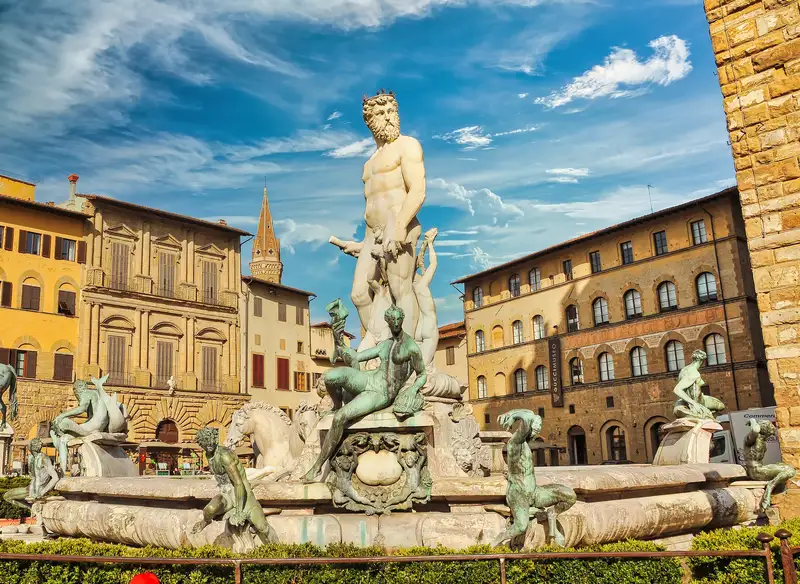 The white marble Fountain of Neptune ringed by bronze figures in Piazza della Signoria, Florence
