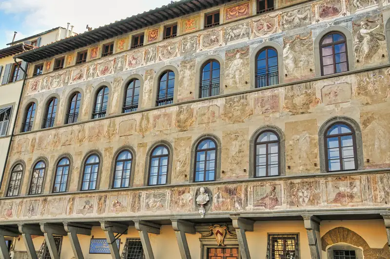 Frescoed facade with arched windows above a portico on Piazza Santa Croce in Florence