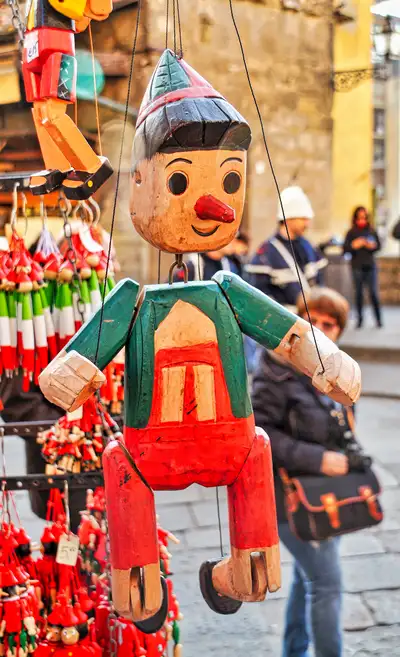Wooden Pinocchio marionette hanging at a souvenir stall in Florence