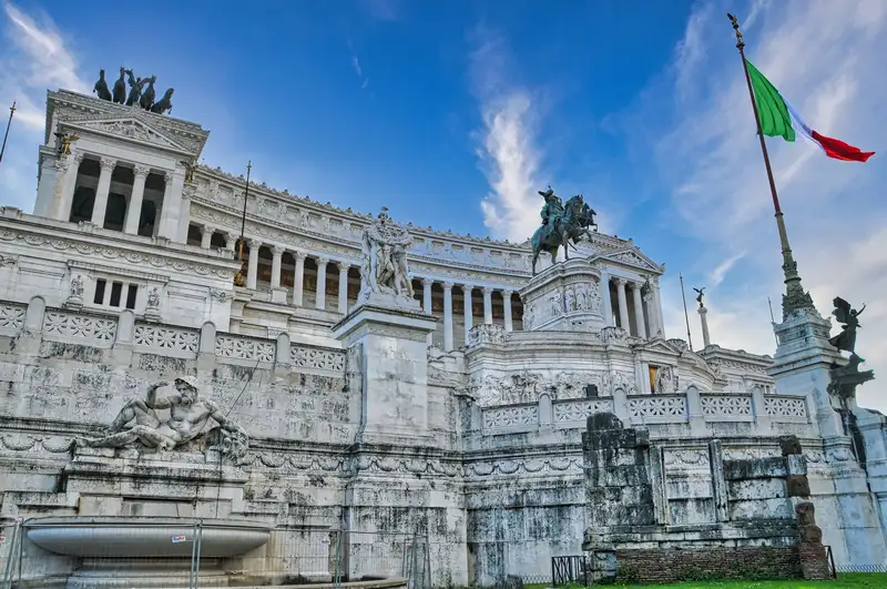 The white marble Altare della Patria monument with the Italian flag, Rome