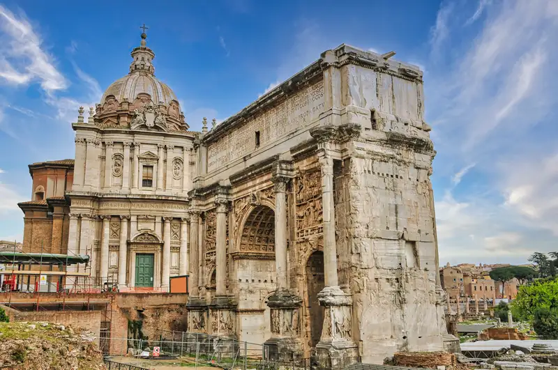 Carved triumphal arch of white marble in the Roman Forum