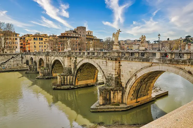 The old arches of Ponte Sant'Angelo crossing the Tiber, lined with statues