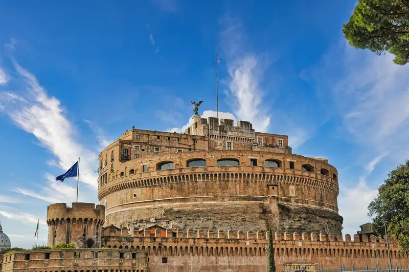 The round fortress of Castel Sant'Angelo rising above its old walls