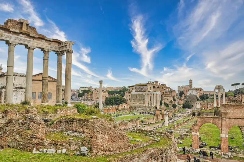 The tall columns of the Temple of Saturn standing over the Roman Forum