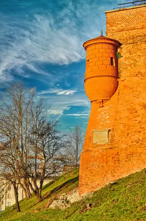 Red brick tower and defensive walls of Wawel Castle on the hill in Krakow, Poland