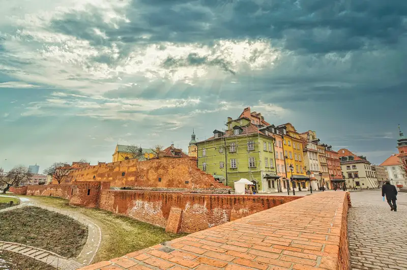 Warsaw Old Town walls with the Royal Castle tower in the distance