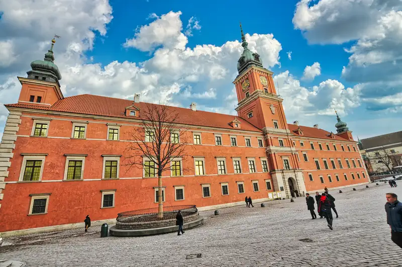 The pink facade and clock tower of the Royal Castle in Warsaw