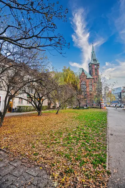 City park with a brick clock tower in Wroclaw